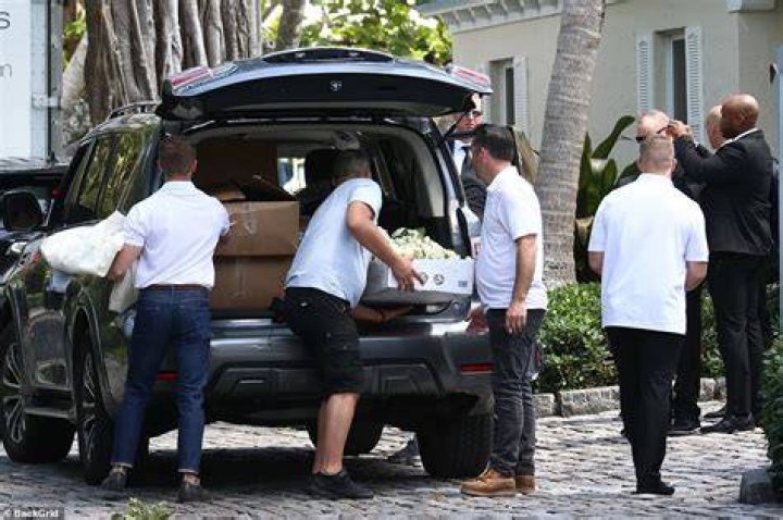 Preparations: Photographs showed huge bunches of flowers being unloaded from a grey vehicle at the Peltz's $103million sprawling family home just hours before Brooklyn, 23, and Nicola, 27, tied the knot in a lavish ceremony